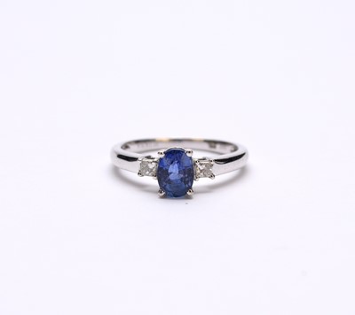 Lot 135 - An 18ct white gold three stone sapphire and diamond ring