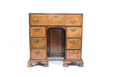 Lot 206 - A George II style feather-banded walnut secretaire kneehole desk