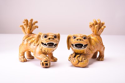 Lot 43 - A pair of Chinese yellow sancai-glazed figures of guardian lions