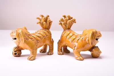 Lot 43 - A pair of Chinese yellow sancai-glazed figures of guardian lions