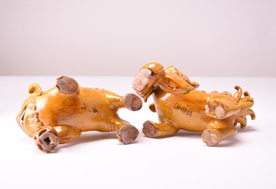 Lot 43 - A pair of Chinese yellow sancai-glazed figures of guardian lions