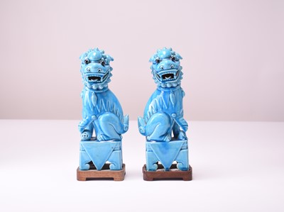 Lot 11 - A pair of Chinese turquoise-glazed figures of guardian lions
