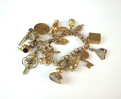 Lot 75 - A 9ct gold bracelet with attached charms