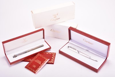 Lot 357 - A Cartier Pasha and a Must de Cartier ballpoint pens