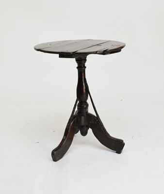 Lot 556 - A 17th/18th century oak tripod occasional table