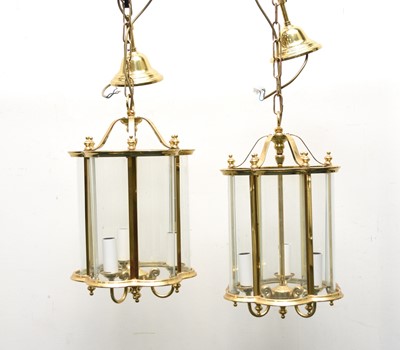 Lot 455 - A pair of reproduction brass and glass lantern ceiling lights