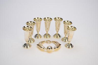 Lot 29 - A Tiffany & Co silver rattle and seven white metal tot cups