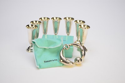 Lot 29 - A Tiffany & Co silver rattle and seven white metal tot cups