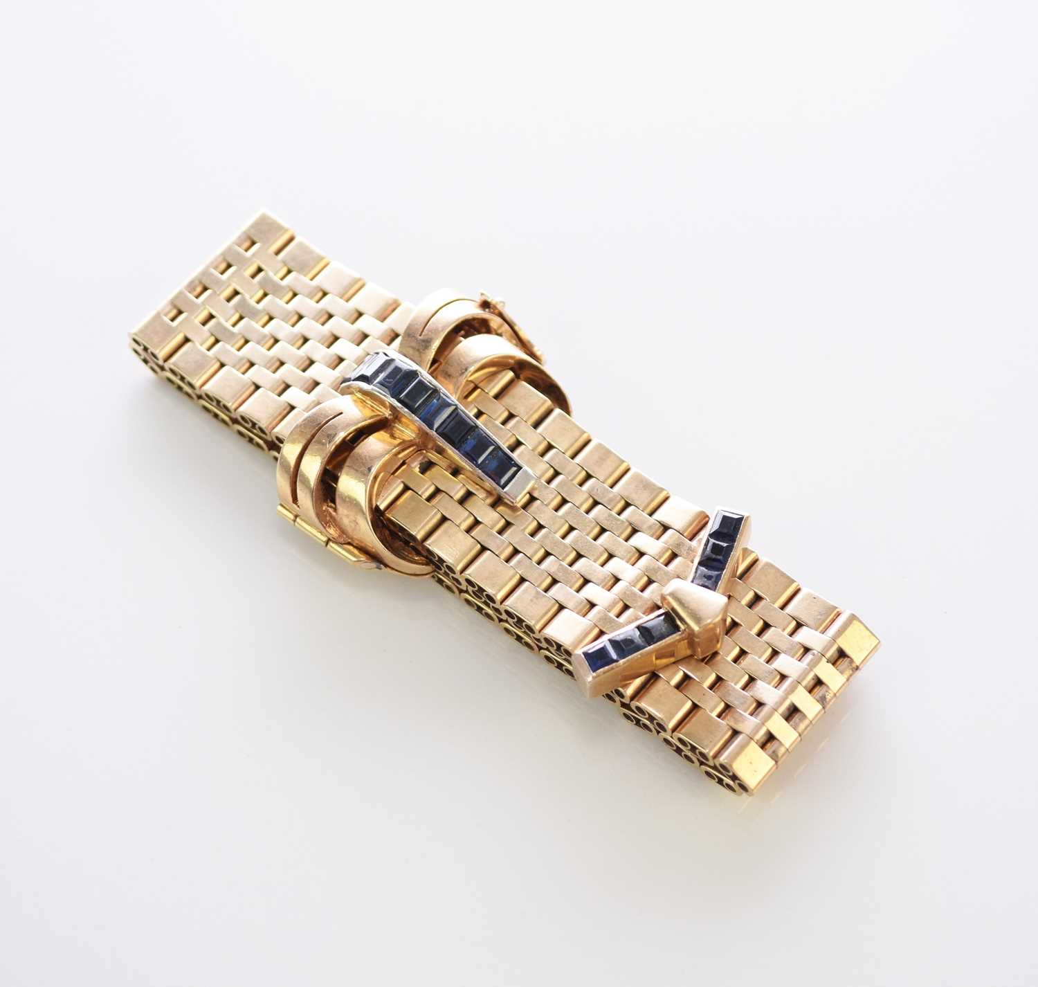 Lot 35 - A 9ct gold untested sapphire set stylised buckle bracelet