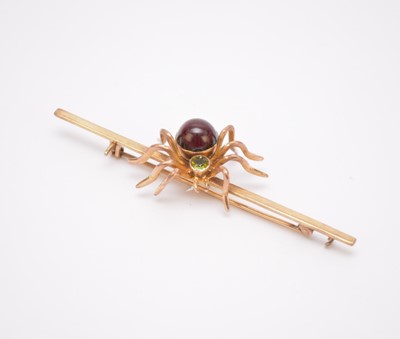 Lot 172 - A cabochon garnet and faceted green stone set spider bar brooch