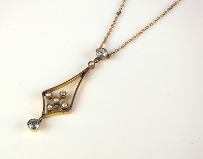 Lot 240 - An early 20th century aquamarine and seed pearl openwork pendant on chain