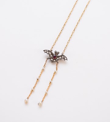 Lot 216 - A ruby and rose cut diamond bat pendant