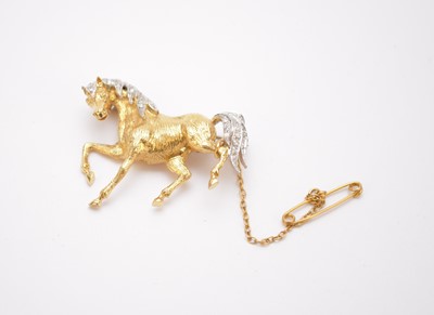 Lot 139 - An 18ct yellow and white gold diamond set prancing horse brooch