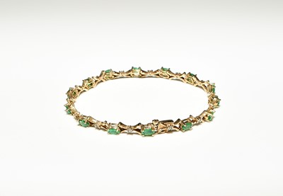 Lot 128 - A 9ct gold emerald and diamond line bracelet