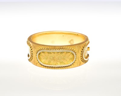 Lot 141 - A late 19th century gilt hinged bangle