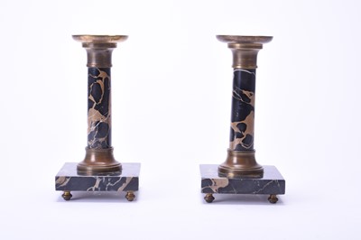 Lot 390 - A pair of gilt metal mounted portoro marble candlesticks