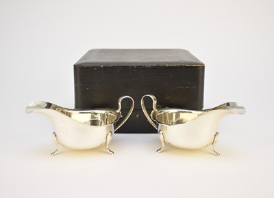 Lot 7 - A cased pair of silver cream jugs
