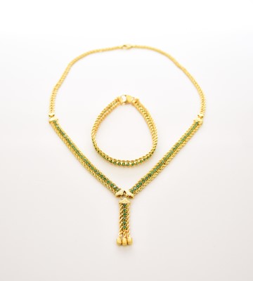 Lot 208 - A yellow metal emerald set necklace with tassel pendant and an emerald set bracelet