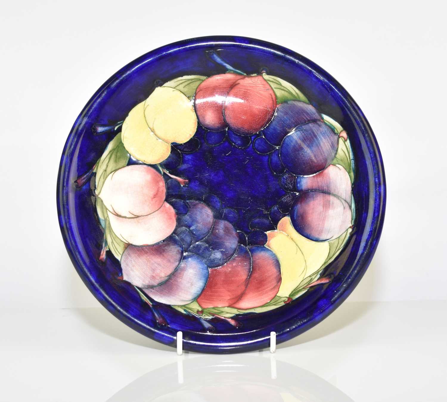 Lot 178 - A Walter Moorcroft 'Wisteria' plate, circa 1957-50