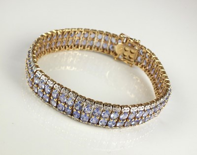 Lot 251 - A tanzanite and diamond line bracelet