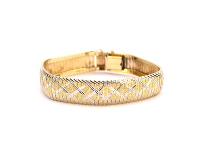 Lot 194 - A yellow and white metal engraved and textured link bracelet