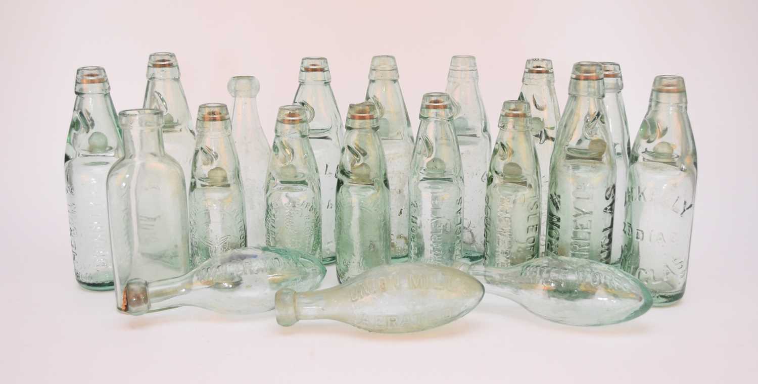 Lot 275 - A collection of glass codd-neck bottles,...