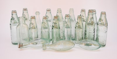 Lot 275 - A collection of glass codd-neck bottles,...