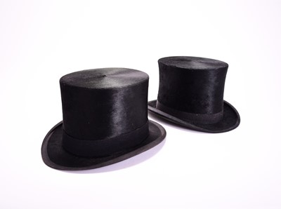Lot 429 - Two black silk top hats, one in leather case