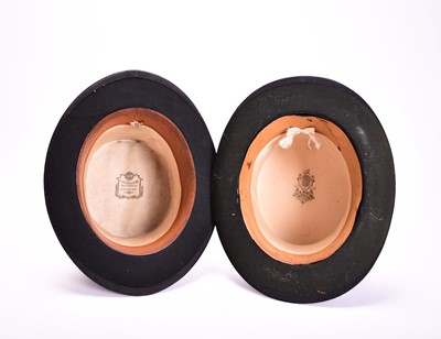 Lot 429 - Two black silk top hats, one in leather case