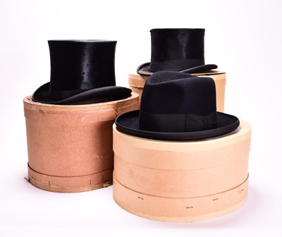 Lot 432 - Two black silk top hats and one homburg, boxed