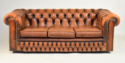 Lot 355 - A tan leather Chesterfield suite of sofa and two armchairs