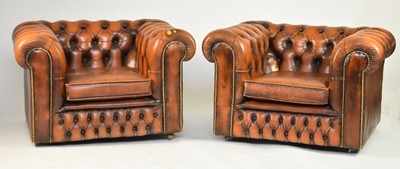 Lot 355 - A tan leather Chesterfield suite of sofa and two armchairs