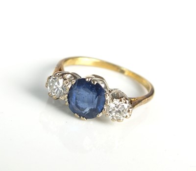 Lot 113 - An 18ct gold three stone sapphire and diamond ring