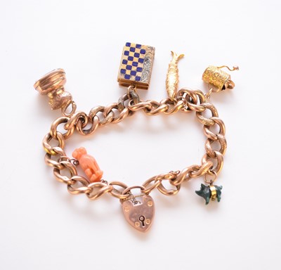 Lot 258 - A 9ct gold charm bracelet with attached charms