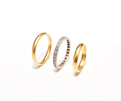 Lot 224 - Two 22ct gold bands and a diamond set ring