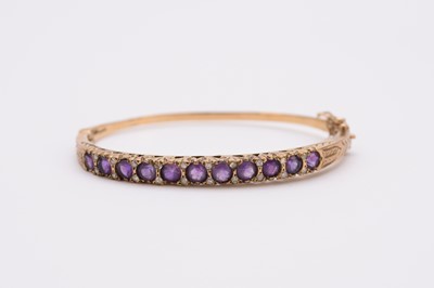 Lot 89 - A 9ct gold amethyst and diamond bangle