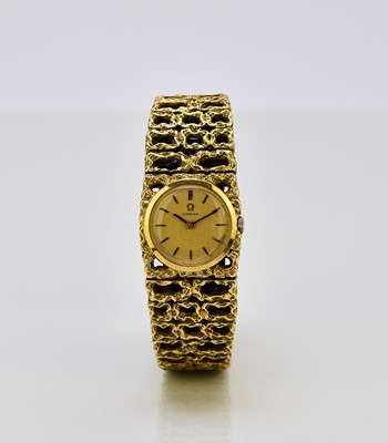 Lot 128 - Omega: A lady's 18ct gold bracelet watch