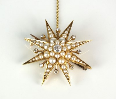 Lot 21 - An early 20th century diamond and split seed pearl starburst pendant / brooch