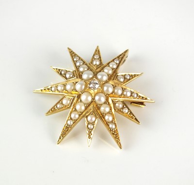 Lot 221 - An early 20 the century diamond and split seed pearl starburst brooch / pendant