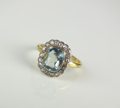 Lot 169 - An 18ct gold aquamarine and diamond cluster ring