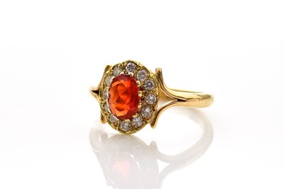 Lot 144 - An 18ct gold fire opal and diamond ring