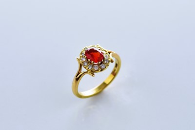 Lot 144 - An 18ct gold fire opal and diamond ring