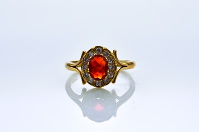 Lot 144 - An 18ct gold fire opal and diamond ring