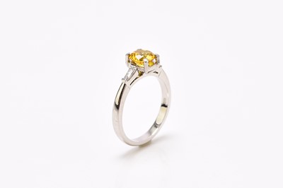 Lot 209 - A platinum yellow zircon and diamond ring