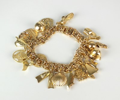 Lot 63 - A yellow metal double scroll link bracelet with attached charms