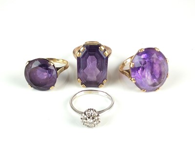 Lot 194 - An 18ct white gold diamond cluster ring and three amethyst rings