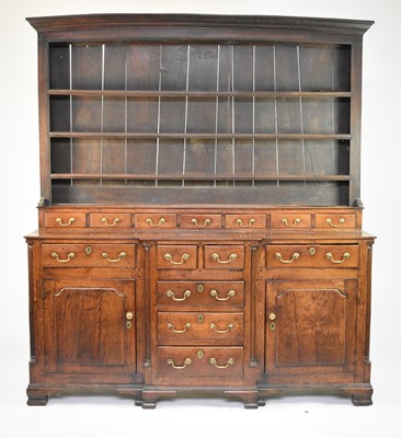 Lot 334 - A George III oak breakfront dresser and rack, North Wales