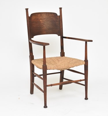 Lot 351 - An Arts and Crafts style rush-seated oak armchair