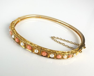 Lot 97 - A Victorian style graduated coral and split pearl hinged bangle