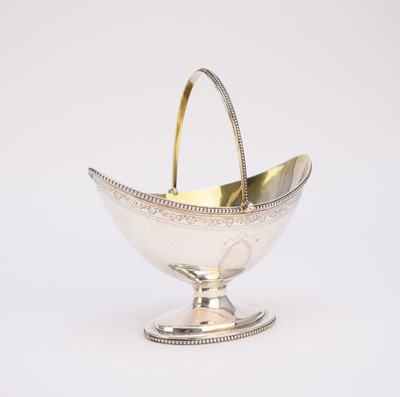 Lot 64 - A George III silver swing handled sugar basket